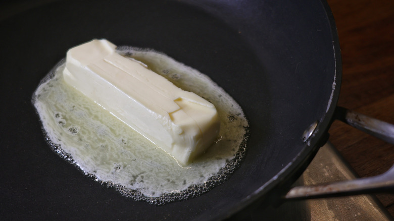 stick of butter melthing in skillet