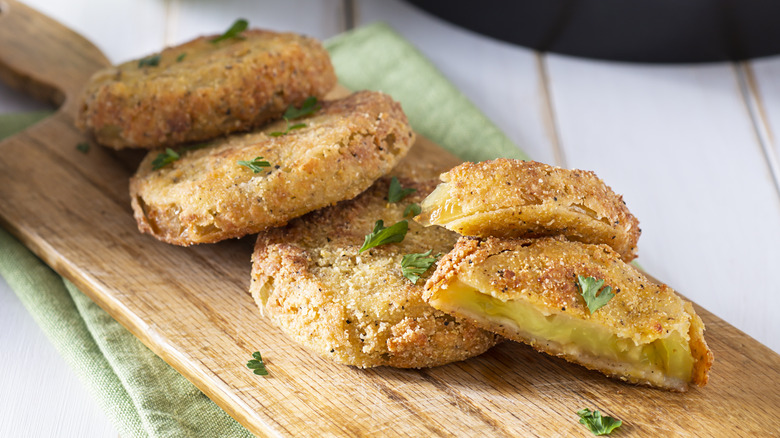 Fried green tomatoes on a cutting board