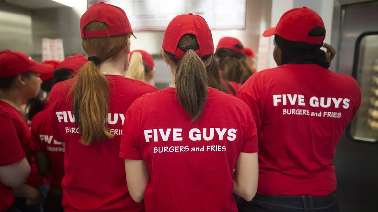 People wearing "Five Guys Burgers and Fries" t-shirts