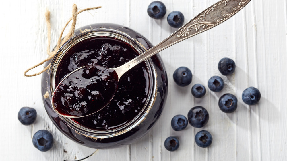 Jar of blueberry jam with spoon