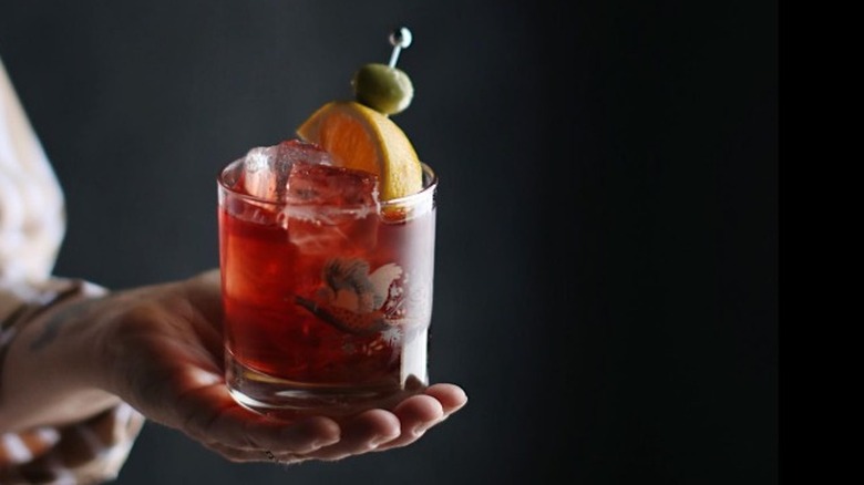 hand holding Negroni Sbagliato 