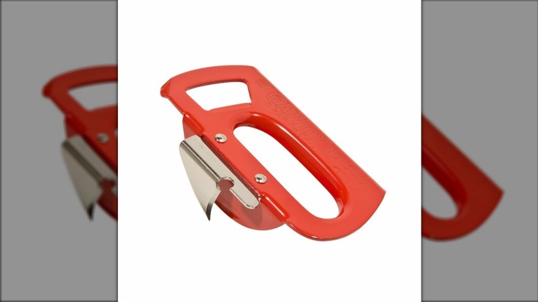 A red Korin can opener on a white background