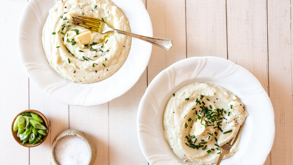 mashed cauliflower with butter and herbs on top