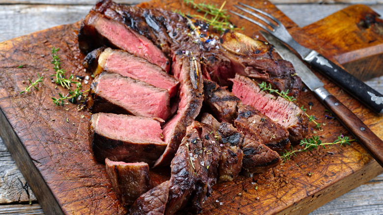 Sliced steak on cutting board