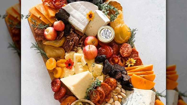 Charcuterie board with yellow and orange 