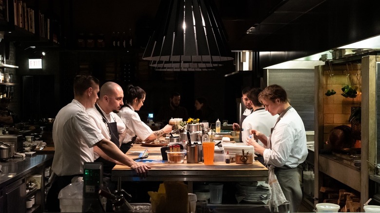 chefs cooking in open kitchen