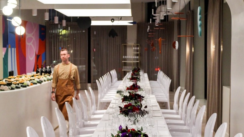 long white tables with flowers and white chairs