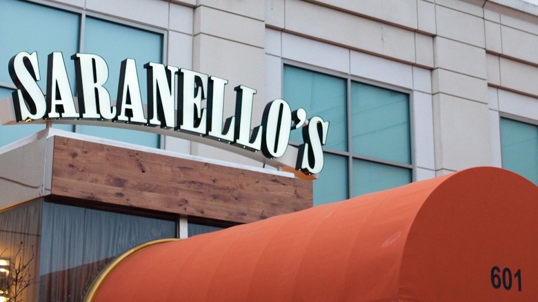 orange covered entrance to Saranellos with white sign