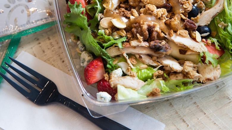 a market salad next to a fork