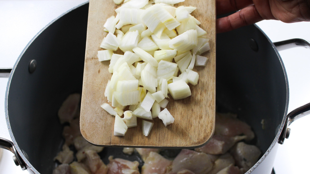 onions on cutting board over pot 