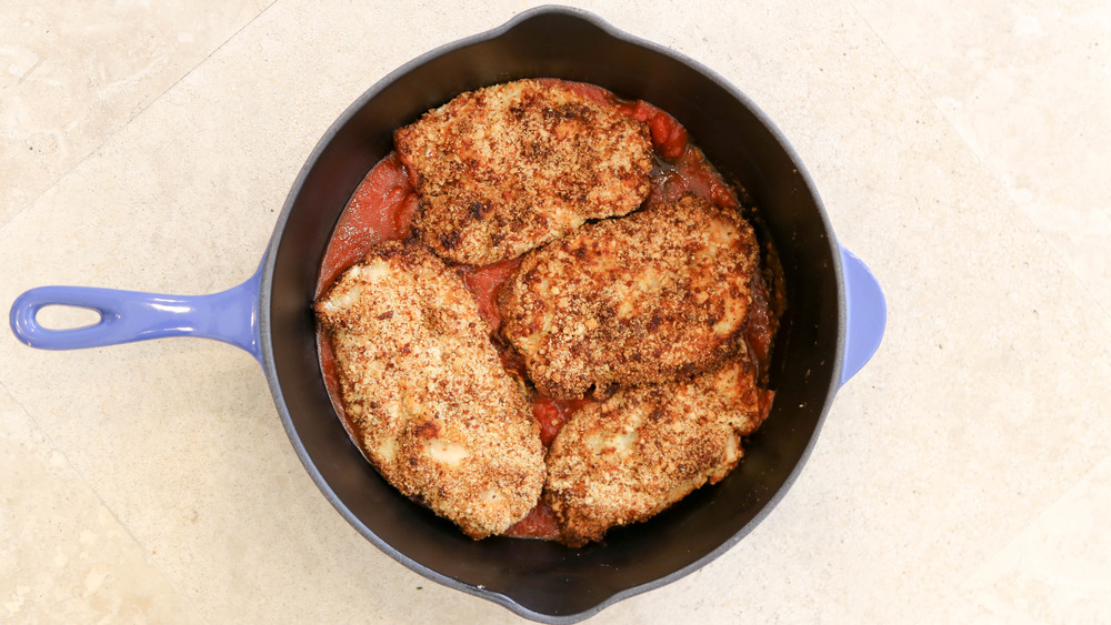 breaded chicken in cast iron pan