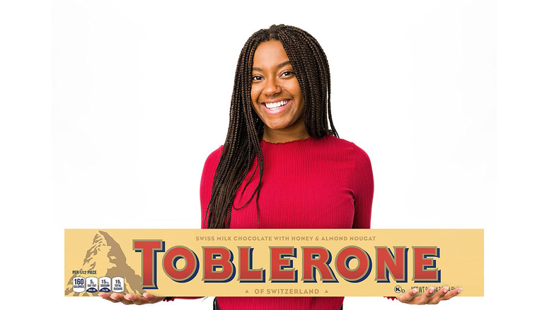 person holding giant Toblerone bar