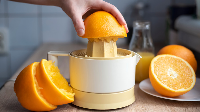 Person juicing citrus fruits