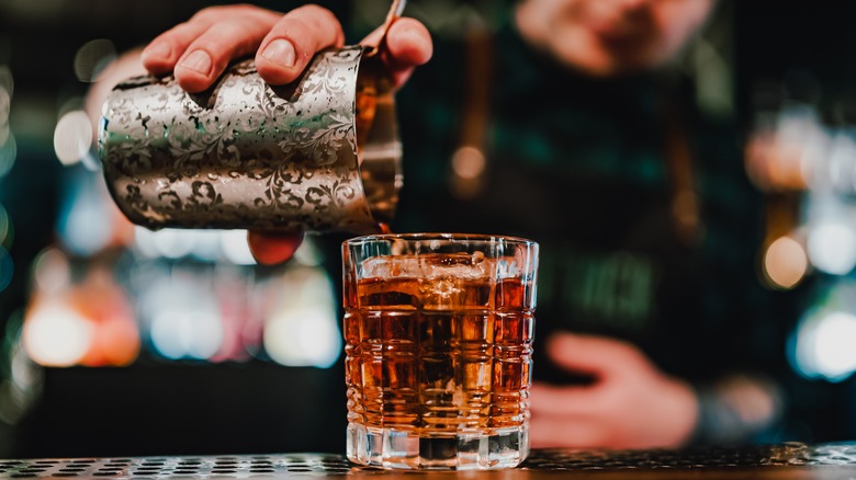 pouring a negroni cocktail