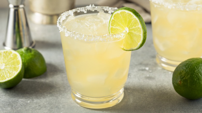 margaritas surrounded by limes