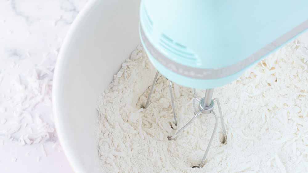 mixing dry ingredients for coconut cake recipe