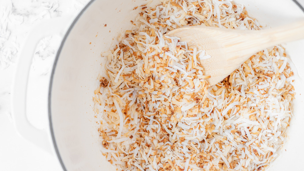 coconut being toasted for coconut cake recipe