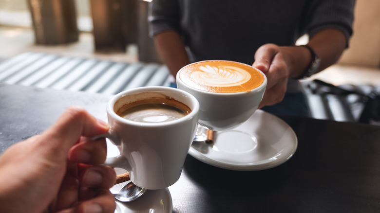 Two people drinking coffee