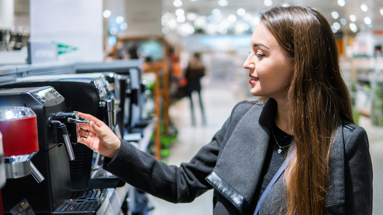 woman choosing coffee machine