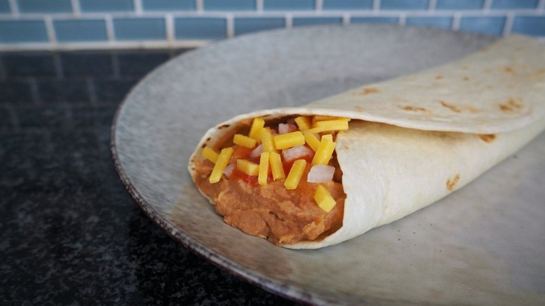 bean burrito with cheese on plate