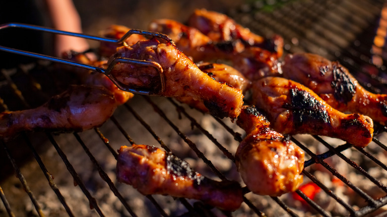 chicken drumsticks cooking on grill