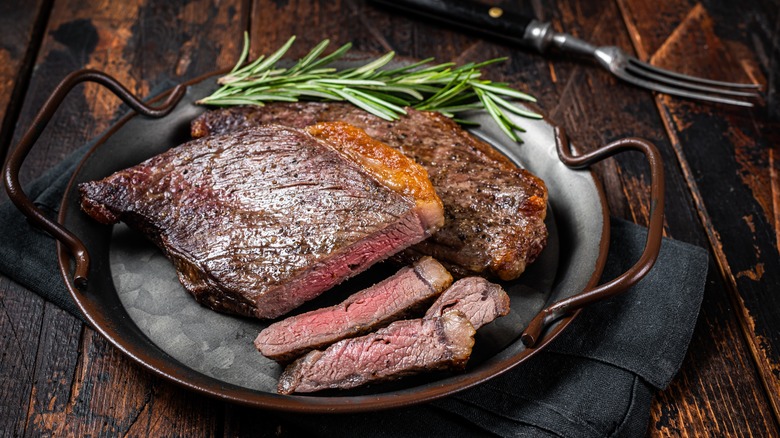 Sliced picanha steak with rosemary