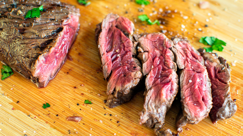 hanger steak on wooden cutting board