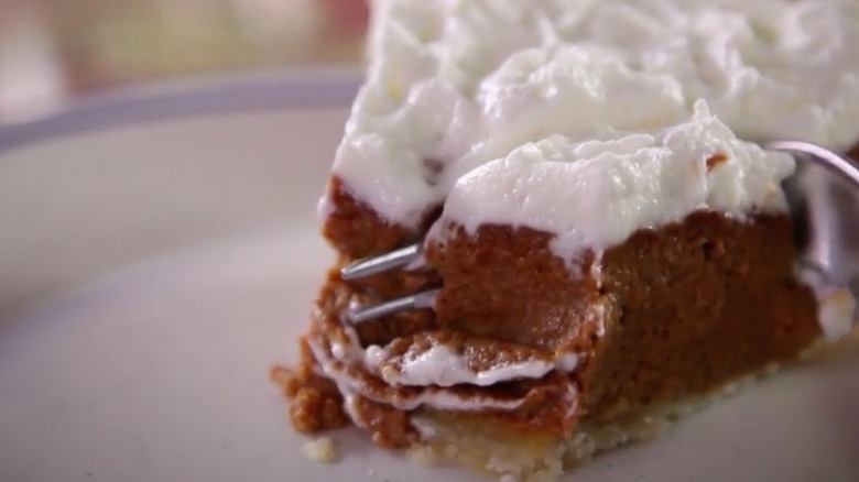 Fork slicing into pumpkin pie