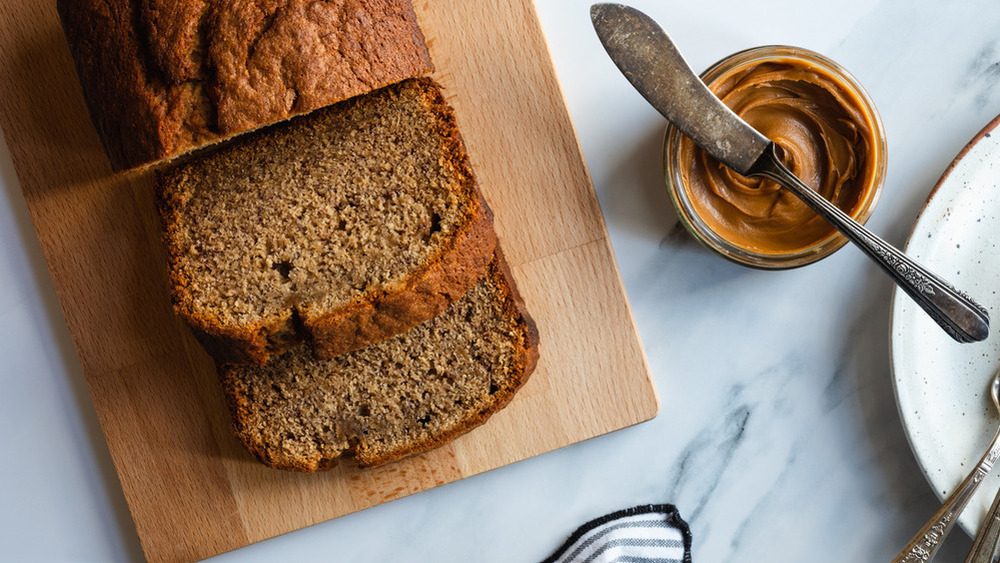 sliced cookie butter banana bread on a wooden cutting board 