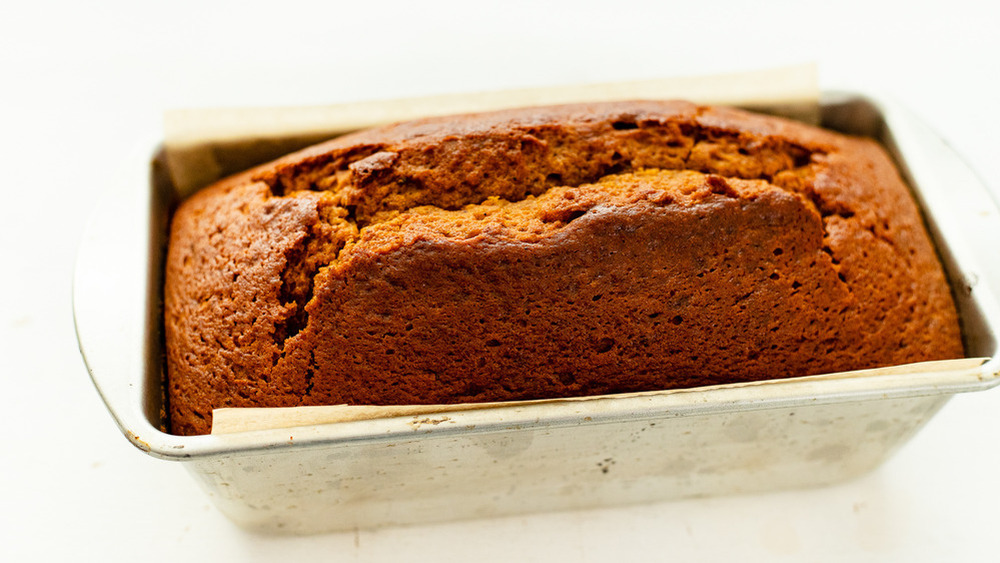 loaf of pumpkin bread in a metal bread pan