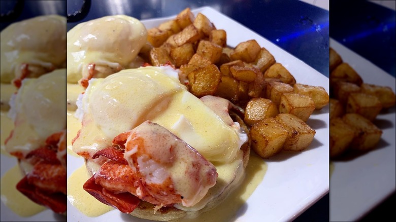 Eggs Benedict with lobster and home fries 