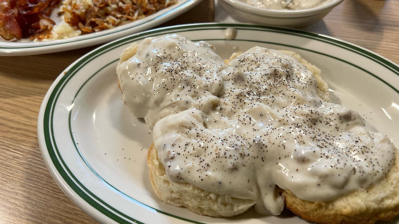 Biscuits and gravy on white plate