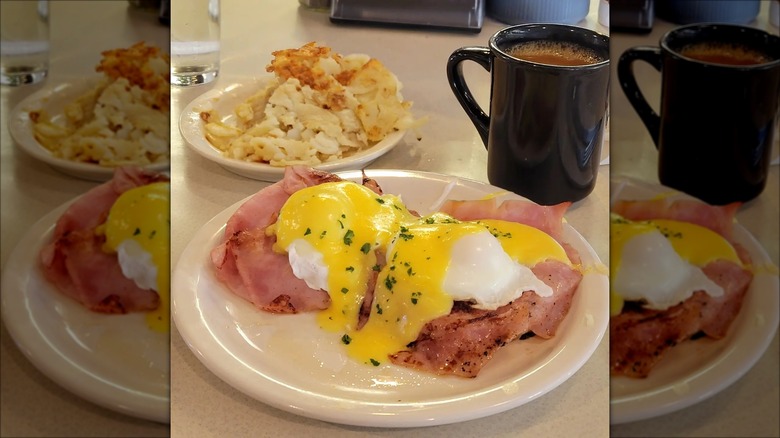 Eggs Benedict with hashbrowns and coffee