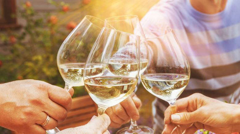 People toasting white wine