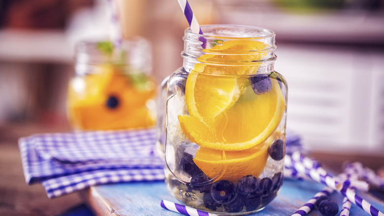 Glass of water infused with oranges and blueberries