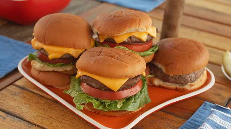 plate of four cheeseburgers