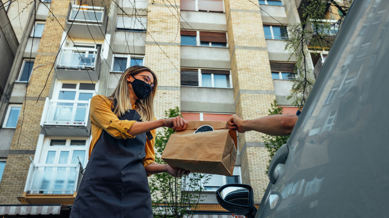 Waitstaff bringing food to car