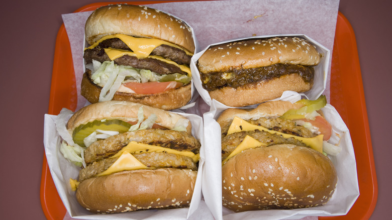 a set of four burger wrapped up