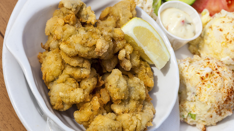 fried clams with lemon wedge