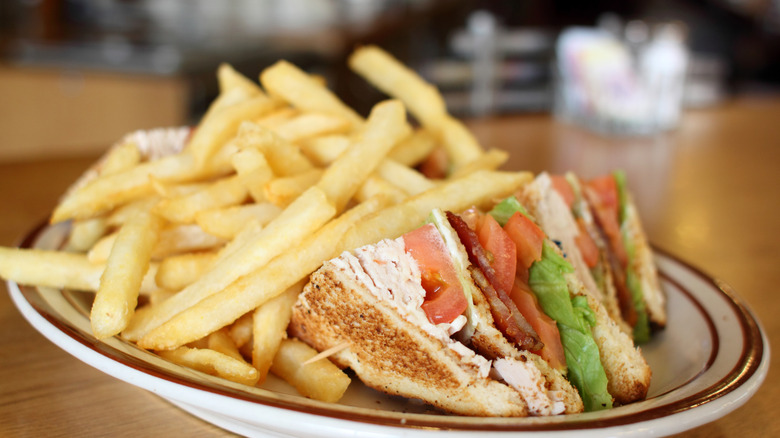 Turkey club sandwich with side of fries