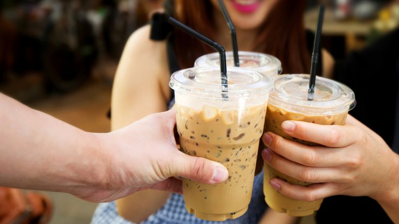 Friends toasting iced coffees