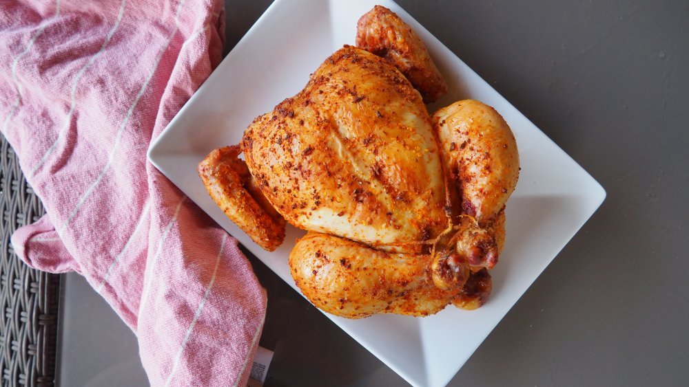 Rotisserie chicken on a white serving dish