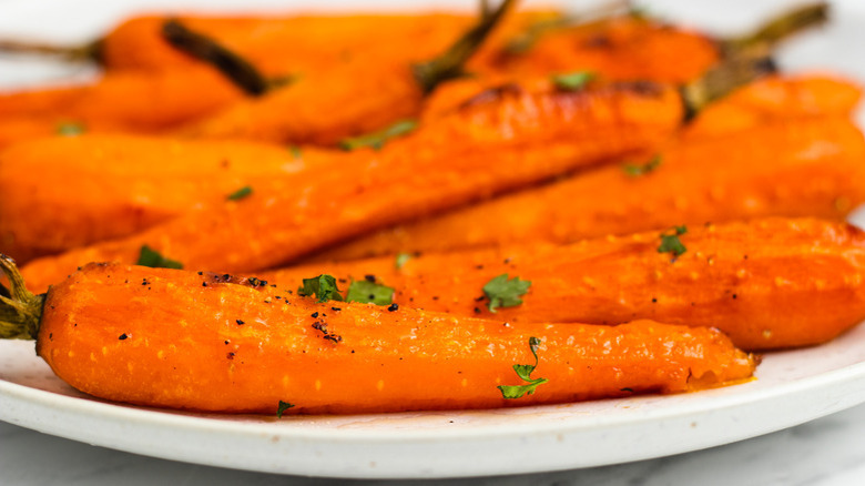 cooked whole carrots on plate