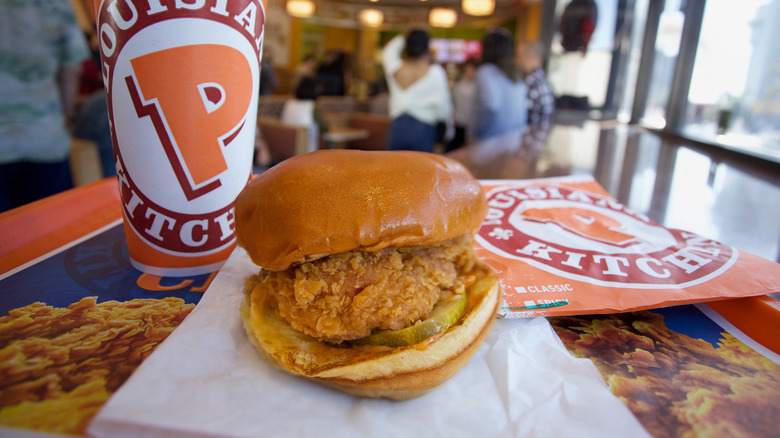 Popeyes spicy chicken sandwich with a drink