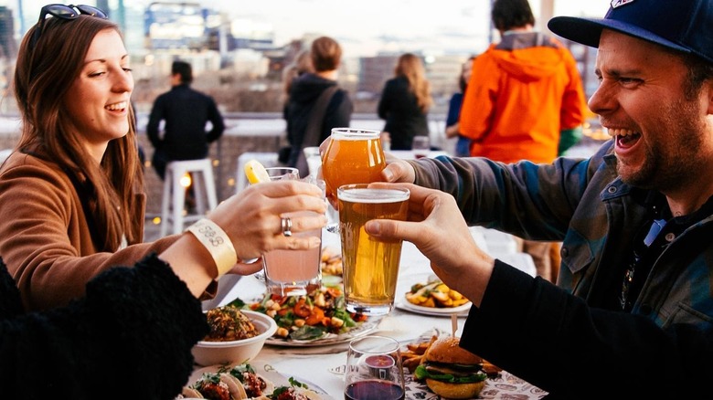 Friends cheers drinks on rooftop