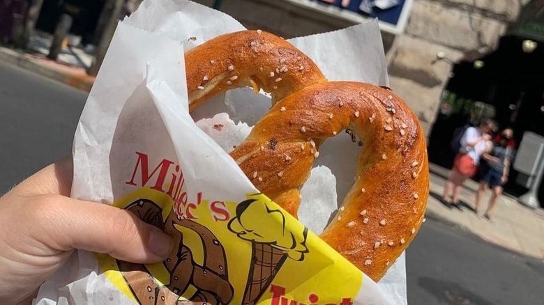 Hand holding soft pretzel