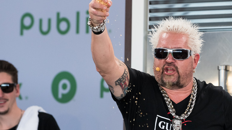 Guy Fieri sprinkles cheese