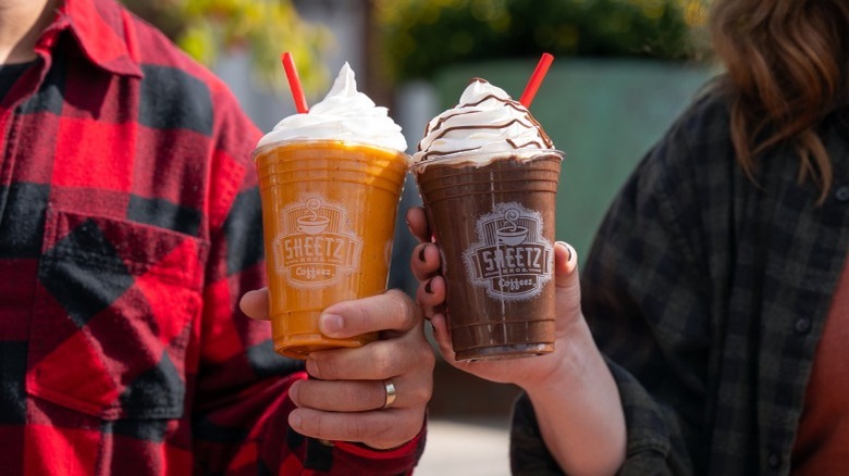 Two people drinking Milkshakes 