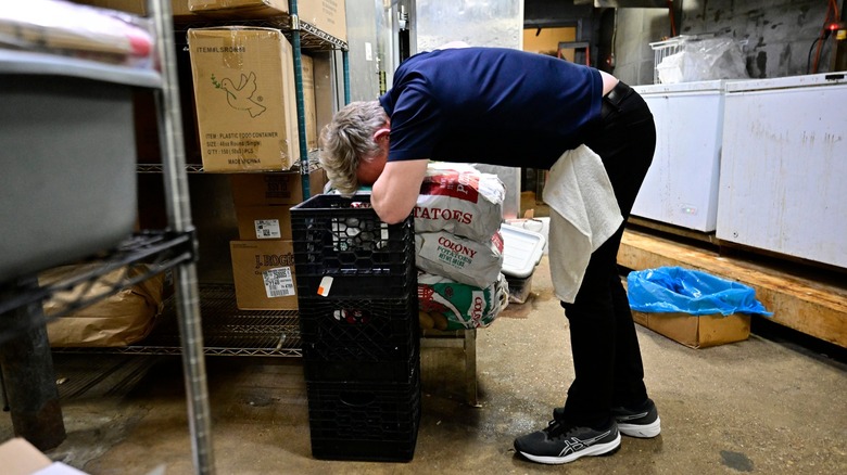 Gordon Ramsay bent over plastic crates