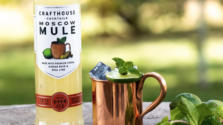 A bottle of Crafthouse's Moscow Mule and the cocktail in a copper cup.